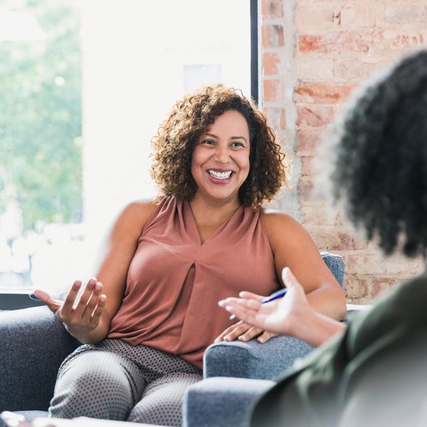 Female Counsellor talking to a woman sat on a sofa